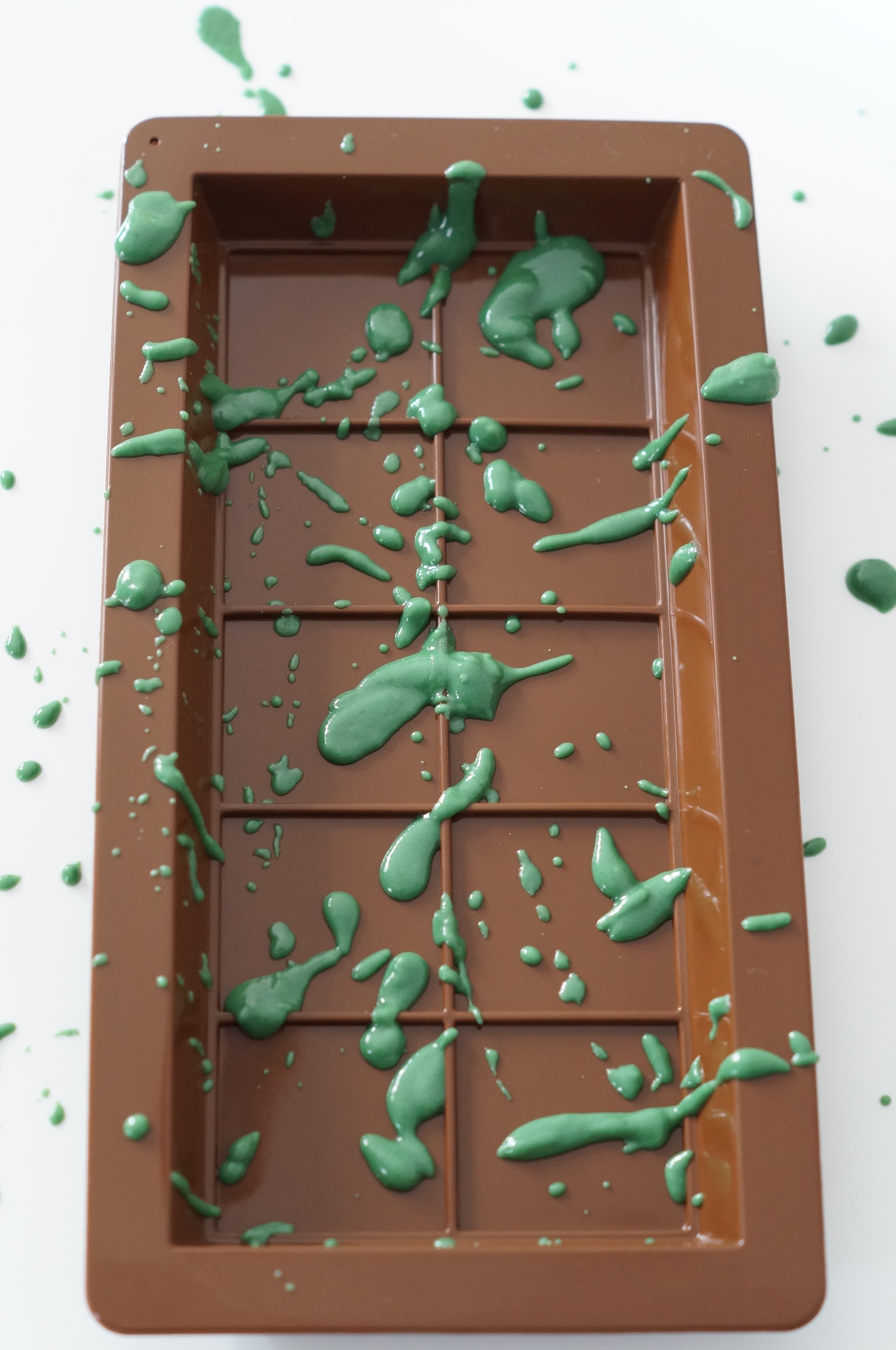 Colored chocolate splatter design in the mold